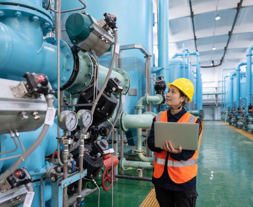 Technician analyzing factory machinery systems