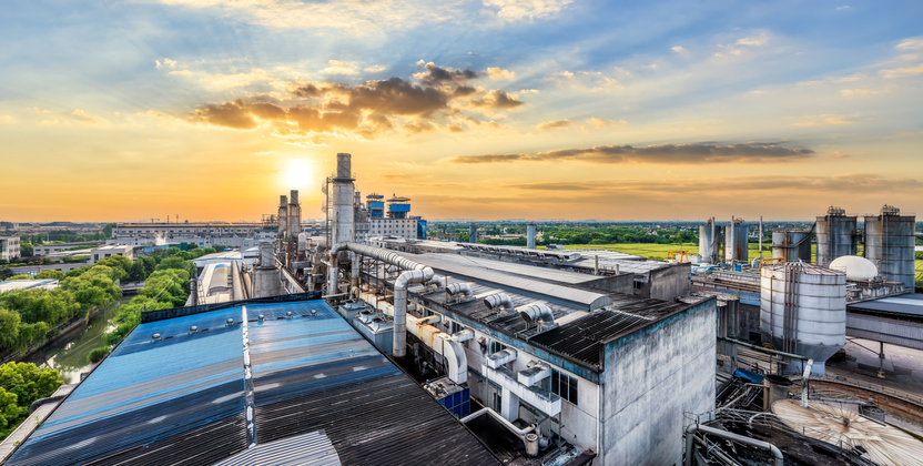 Elevated view of an industrial plant, seen during the warm colors of sunset.